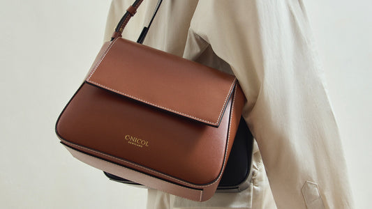 A tan C.Nicol shoulder bag pictured on a person from the side