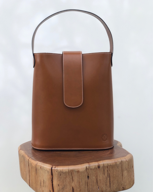 CNicol Brown Leather Holly Bag on top of Brown Wooden Log Slice