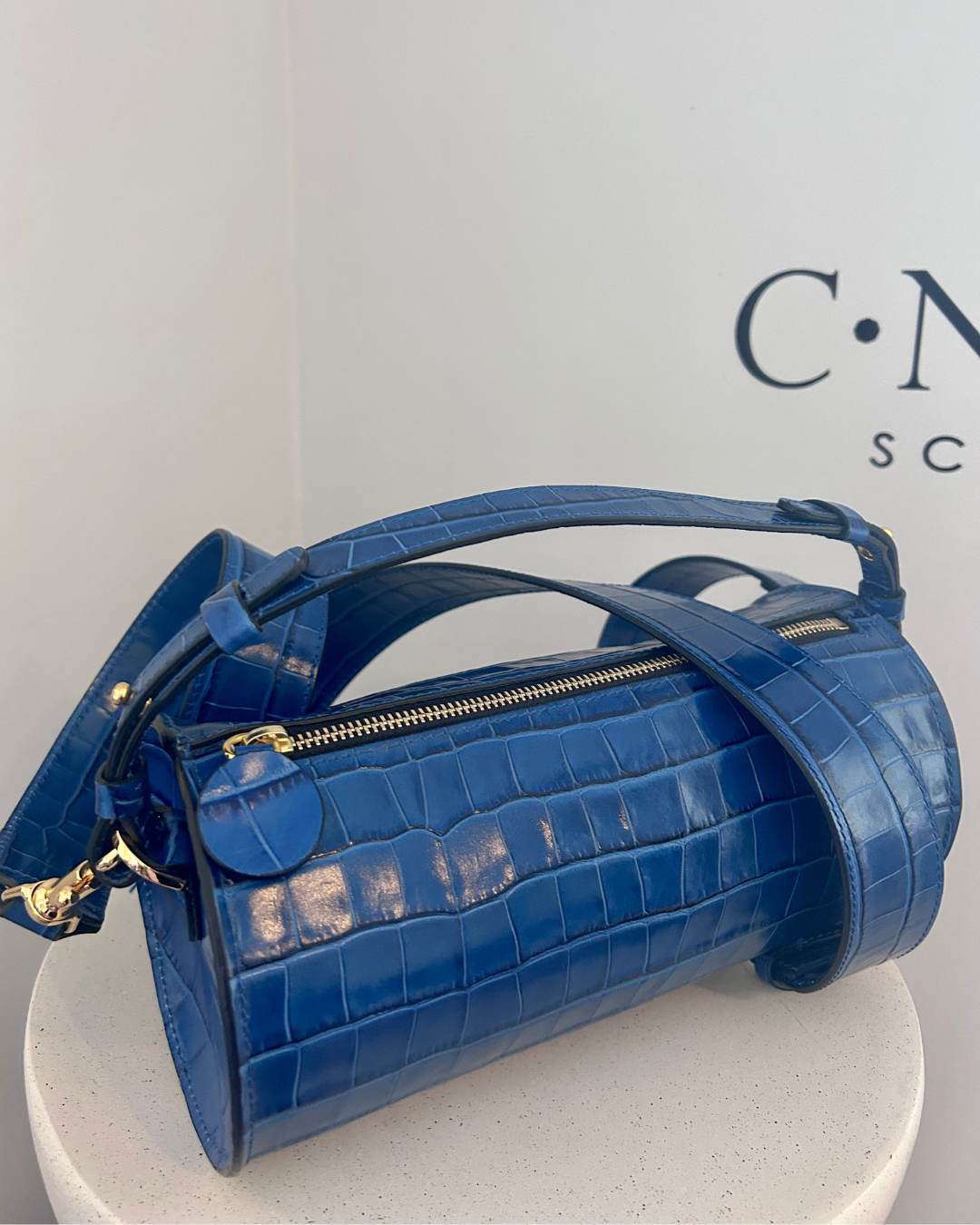 CNicol Blue Leather Croc Evie Bag with Shoulder Strap on White Base 