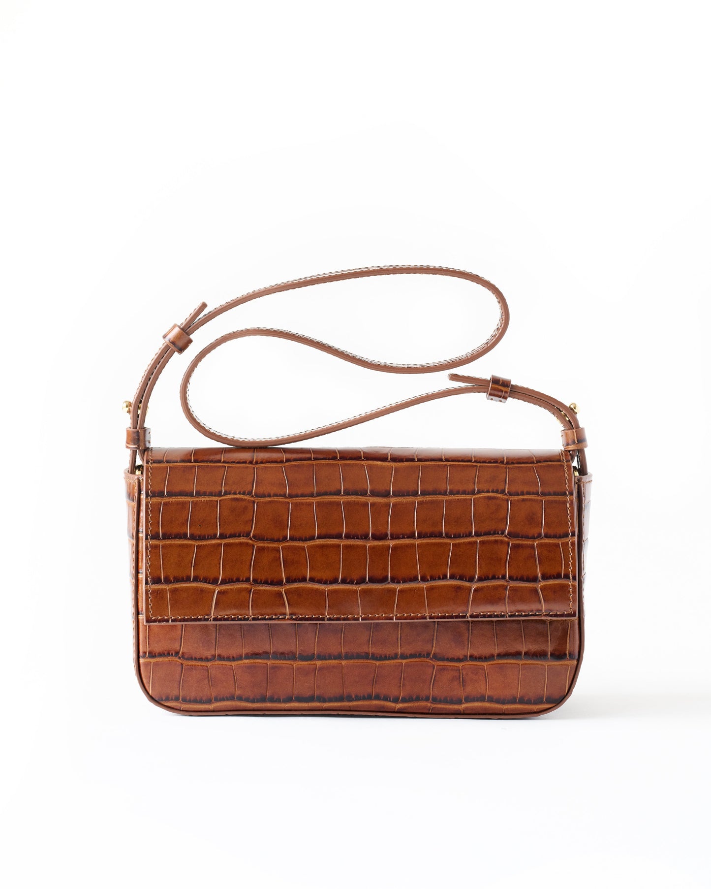 Brown crocodile-patterned handbag on a white background