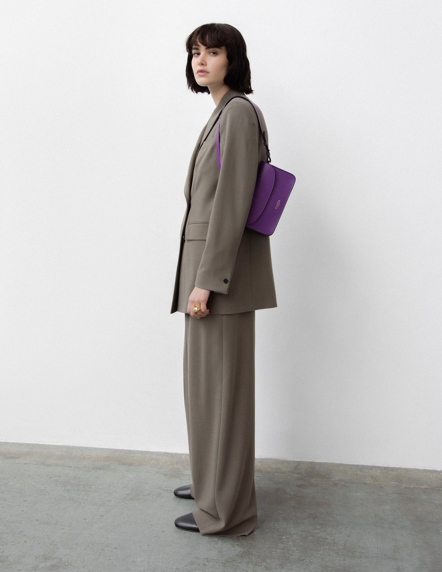 CNicol Purple Leather Bag worn by Model wearing Brown Suit