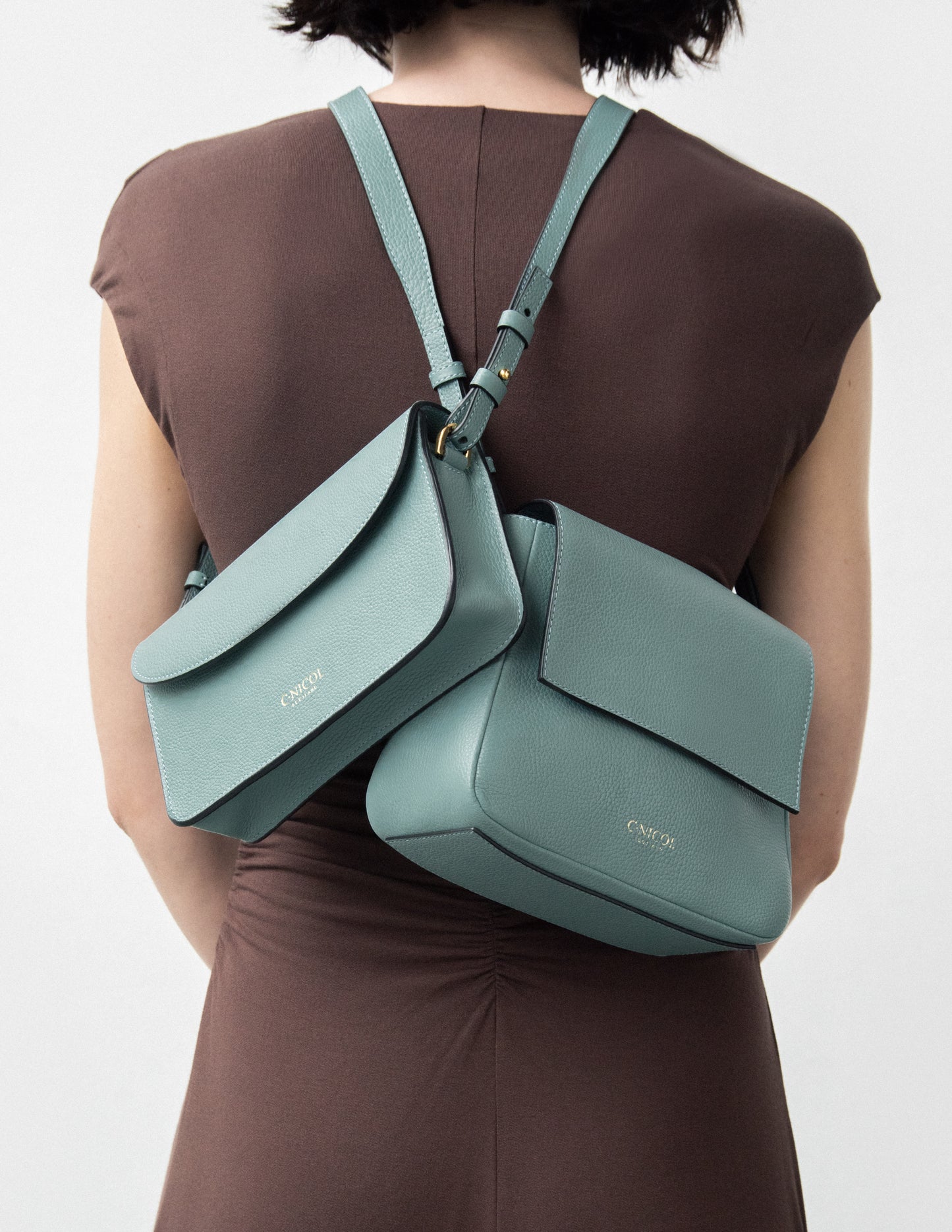 CNicol Green Leather Kate and Fia Bags worn model facing backwards in brown with bags crossing over each other