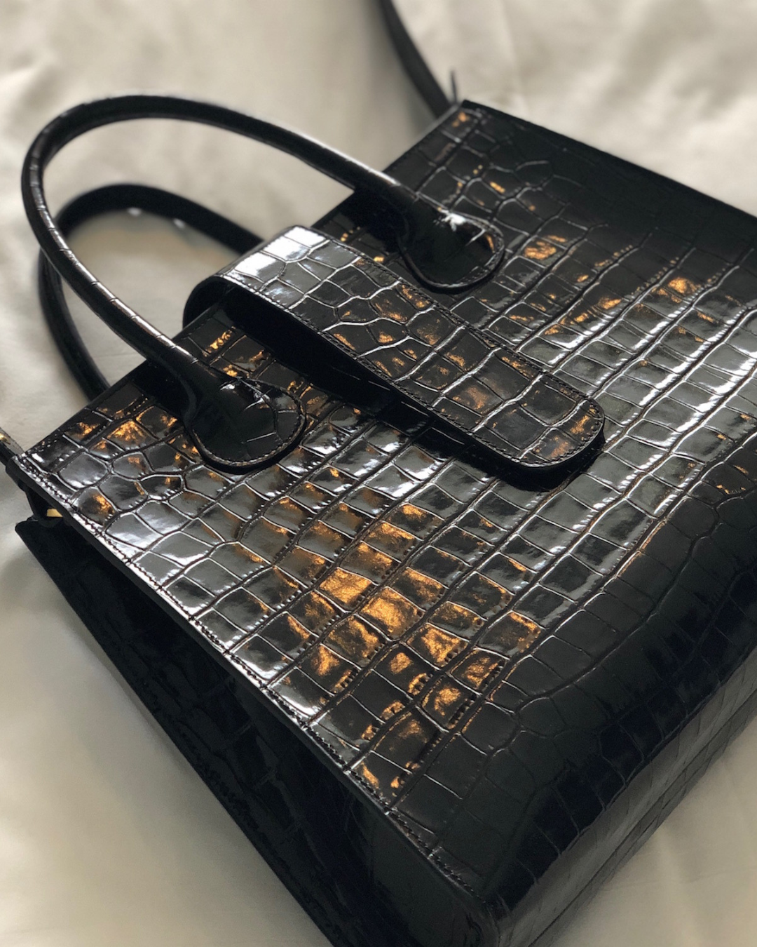 CNicol Black Croco Leather Rosa Bag against a white crushed fabric background